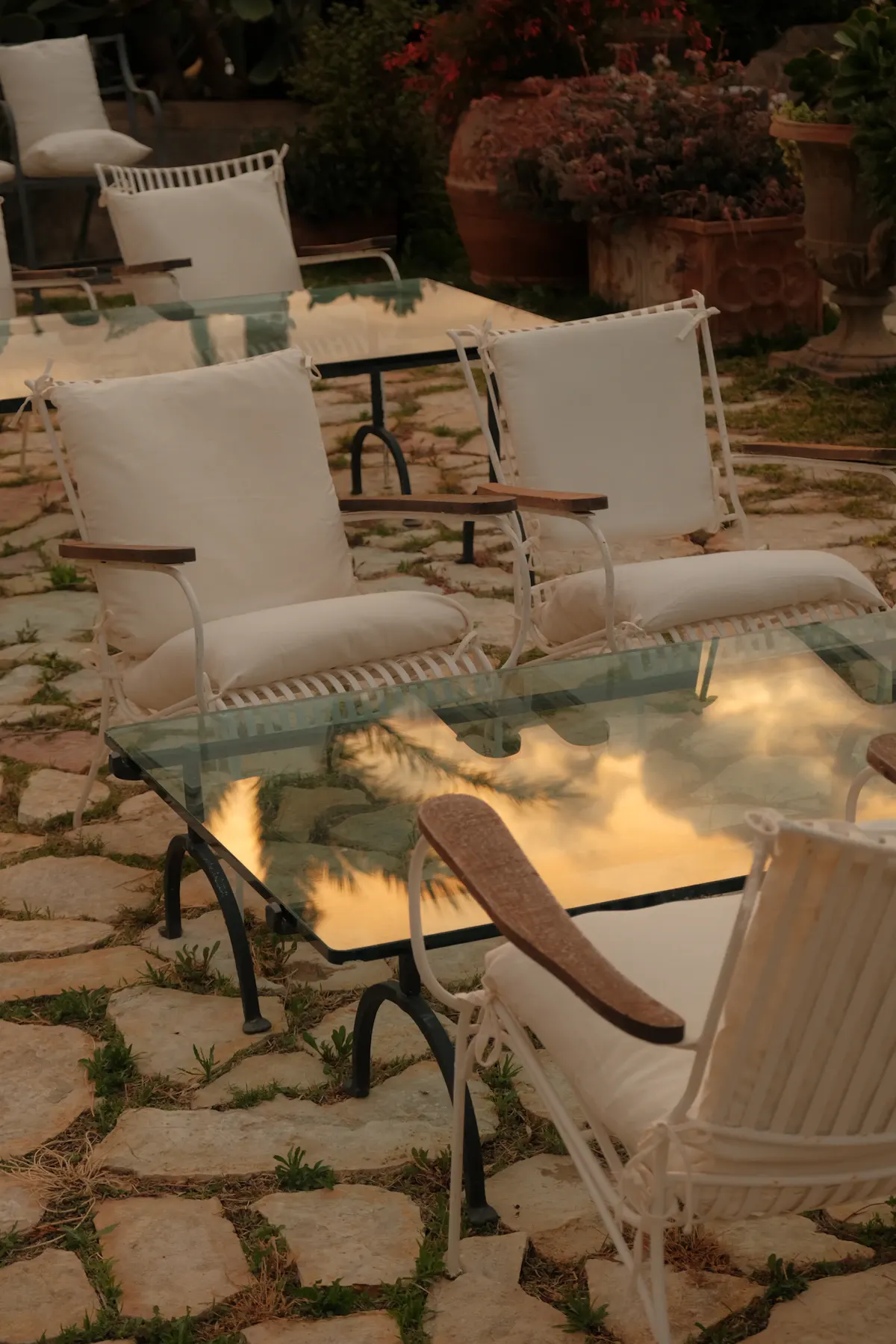 Natural stone patio beside outdoor seating at night