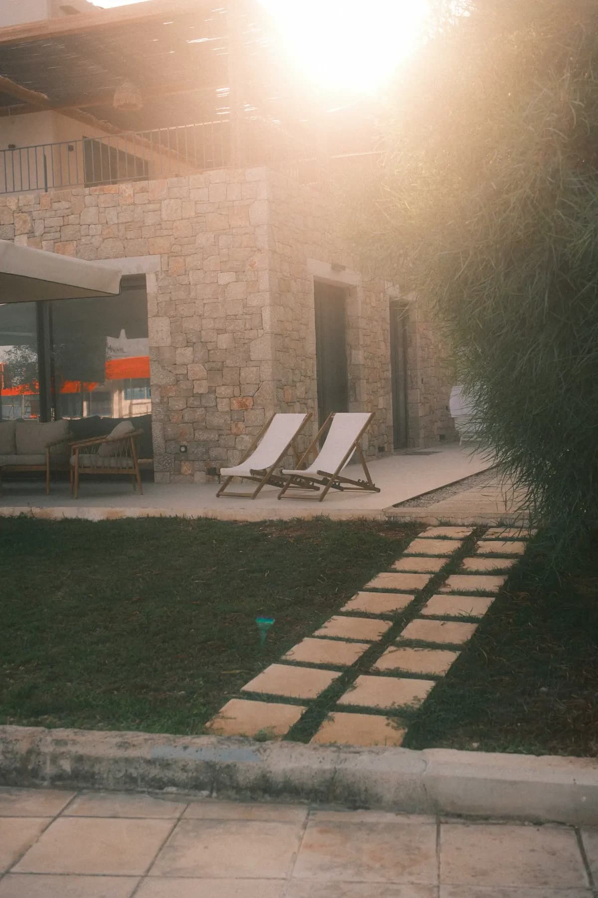 Stepping stones across a lawn beside a terrace