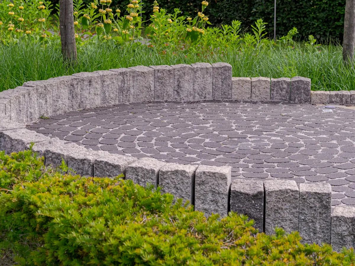 Circular paved seating area with a low retaining wall