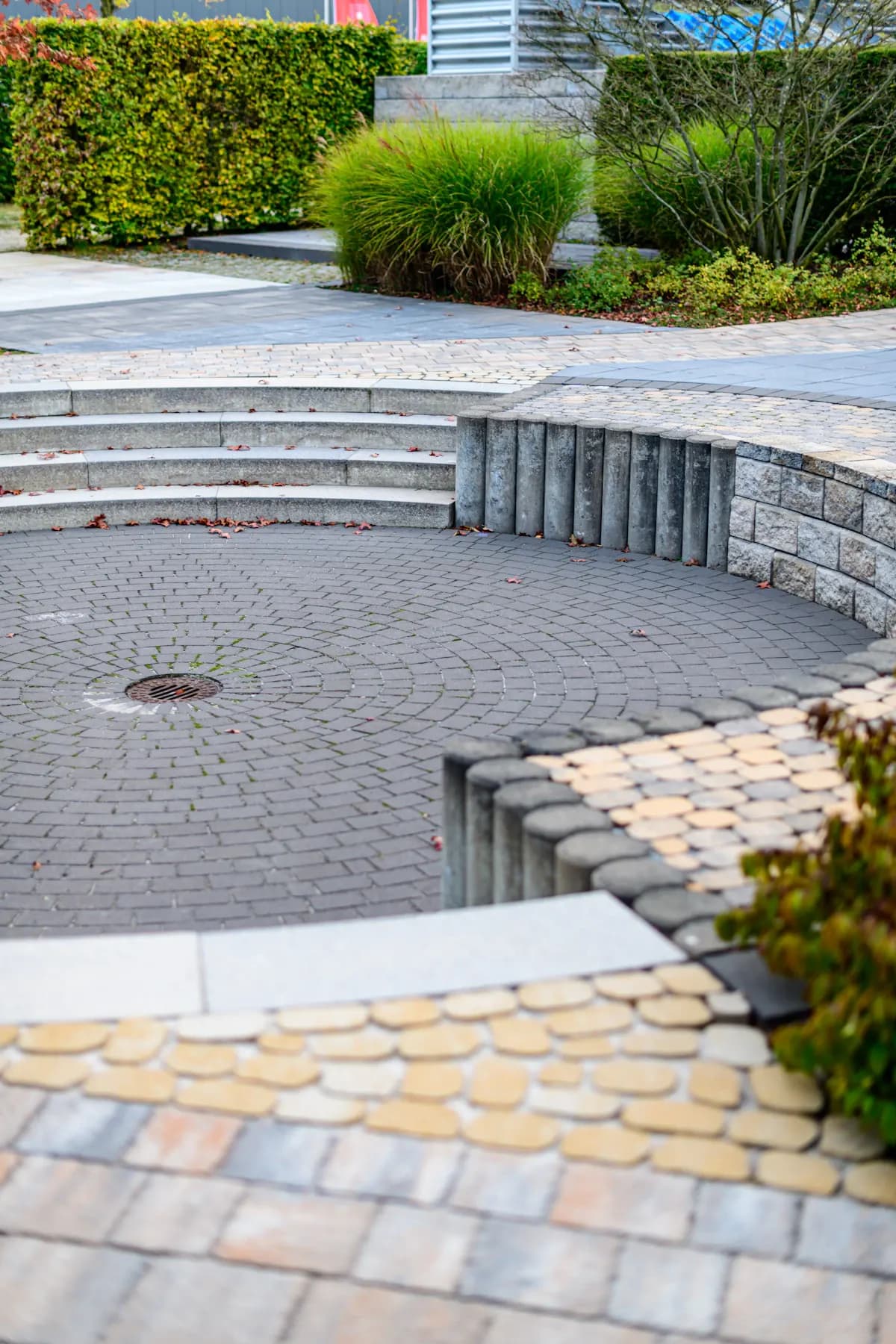 Paved terrace with curved steps and contrasting stone borders